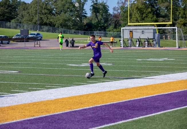 a Bethel athlete player dribbles the soccer ball during a match