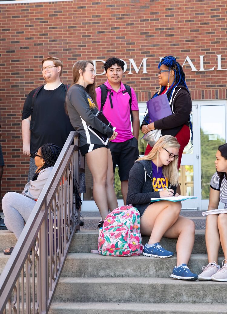 students gather outside of class