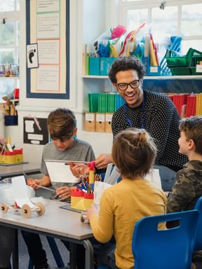 a teacher works with kindergarten-aged children