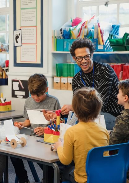 a teacher works with kindergarten-aged children