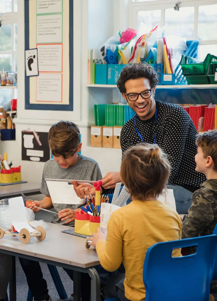 a teacher works with kindergarten-aged children