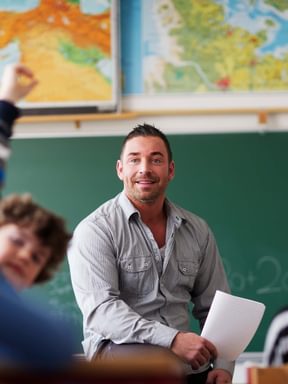a teacher leads class from his desk