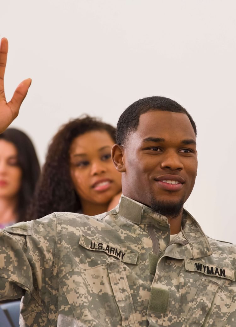 a veteran raises his hand during lecture