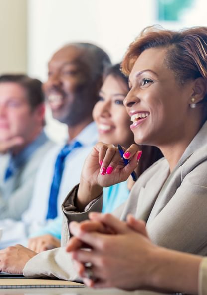 a group of business people listen to a presentation