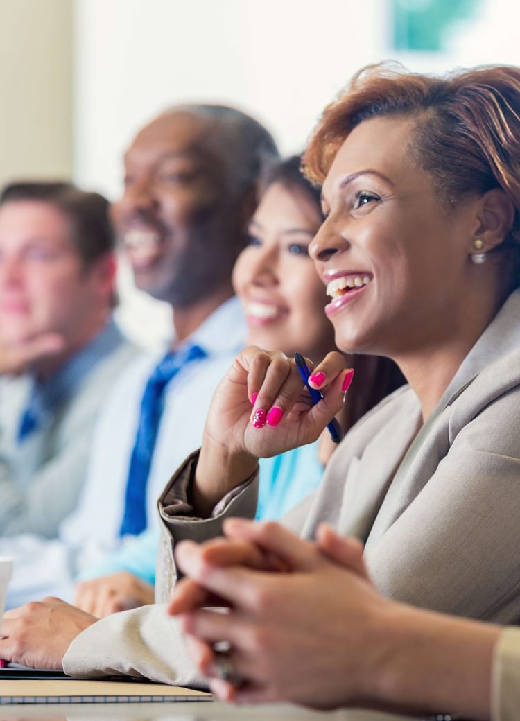 a group of business people listen to a presentation