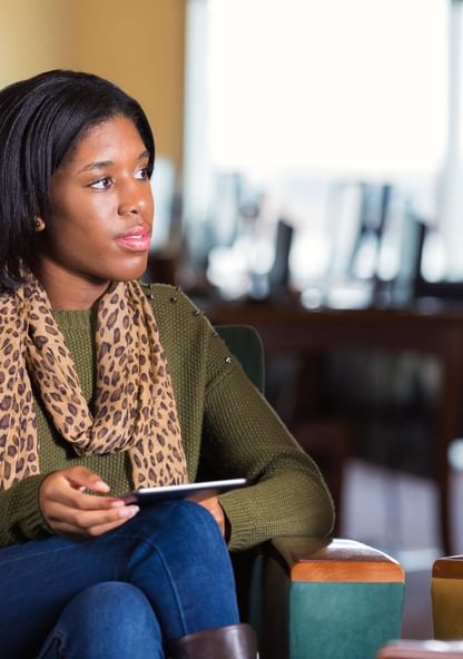 a student takes notes during a group discussion
