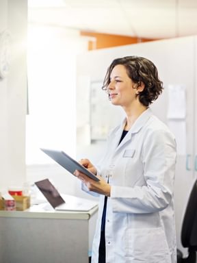 a PA takes notes in a doctor's office