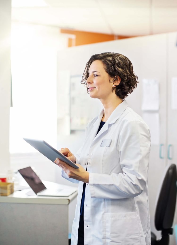a physician assistant works on a chart in a lab