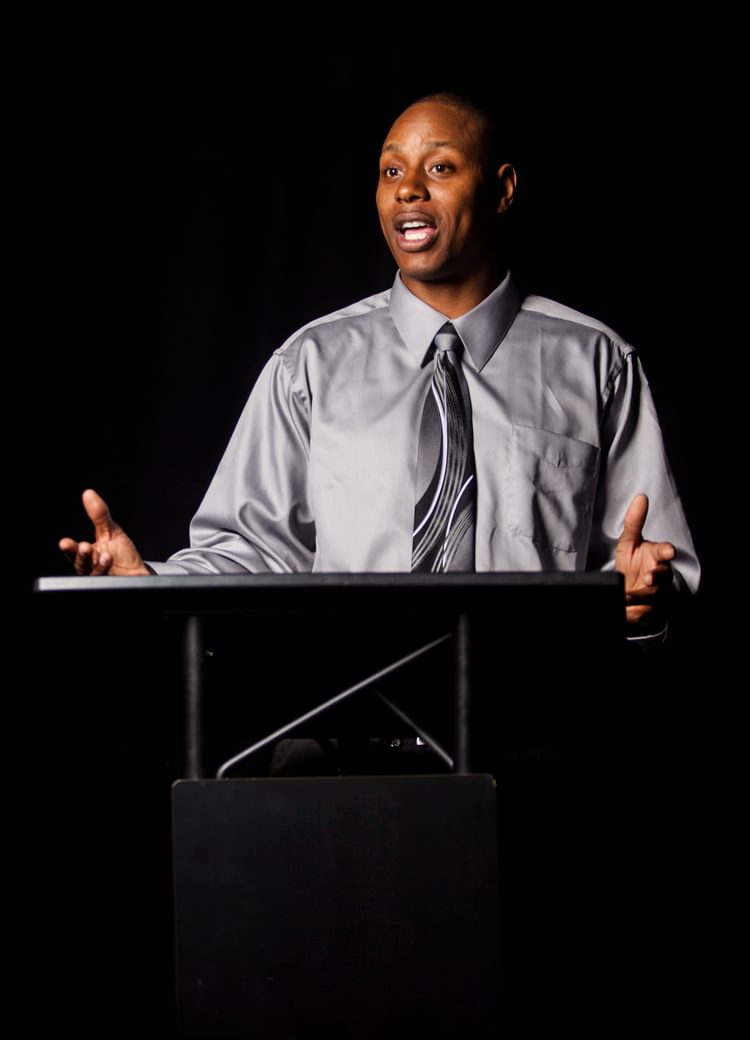 a man delivers a lecture from behind a podium