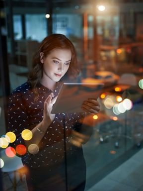 a female uses a tablet inside a business office