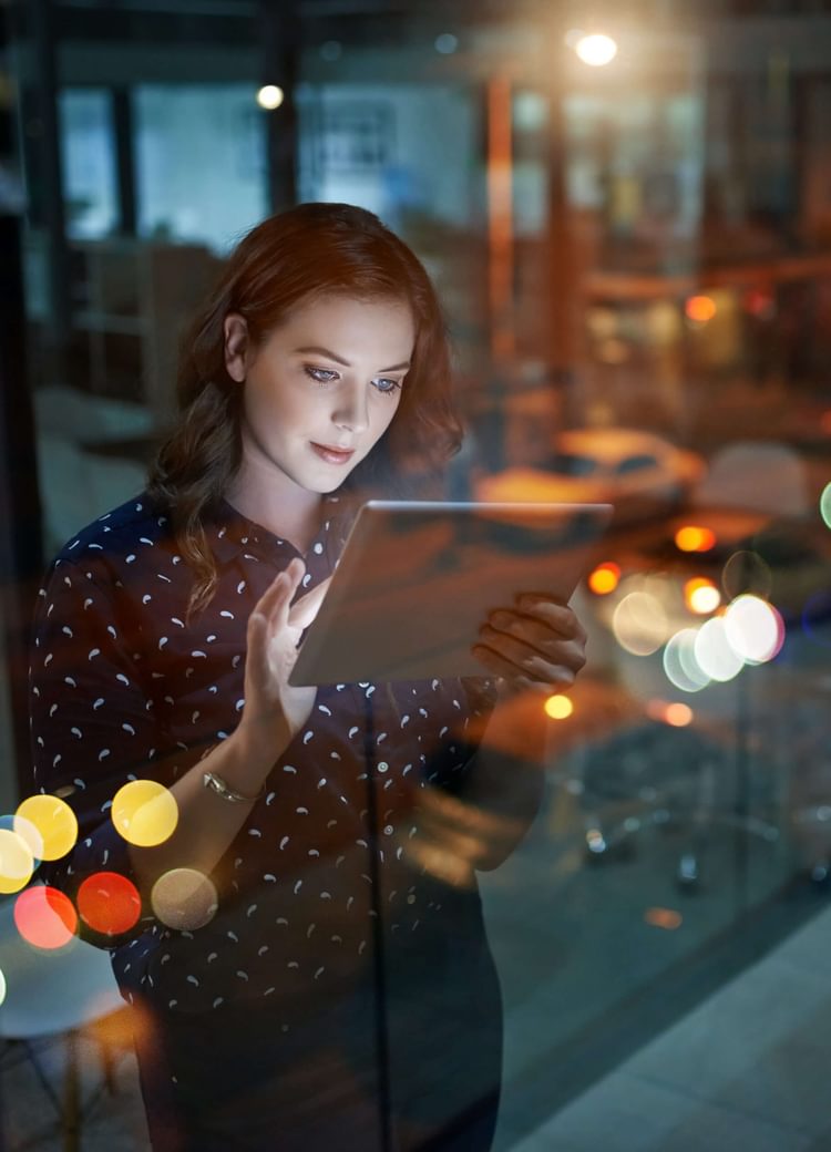 a female uses a tablet inside a business office