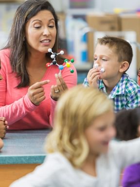 a teacher leads exceptional children through a science lesson