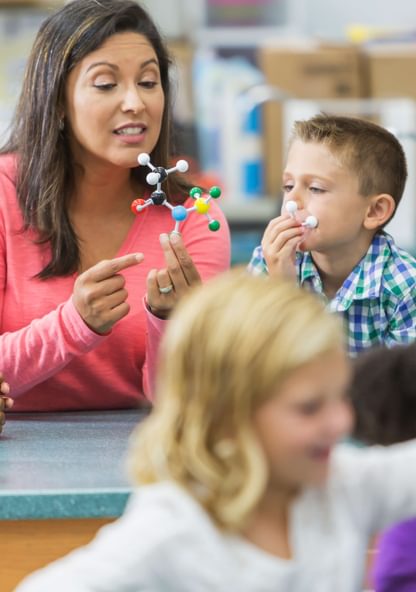 a teacher leads exceptional children through a science lesson
