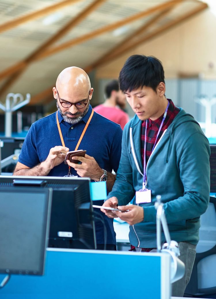 IT professionals work on a machine in a computer lab