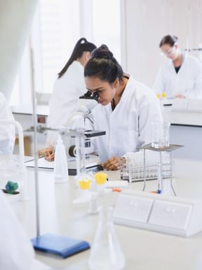 a student uses a microscope during biology lab