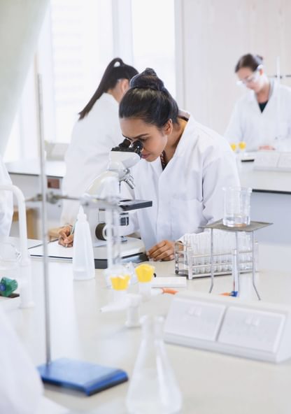 a student uses a microscope during biology lab