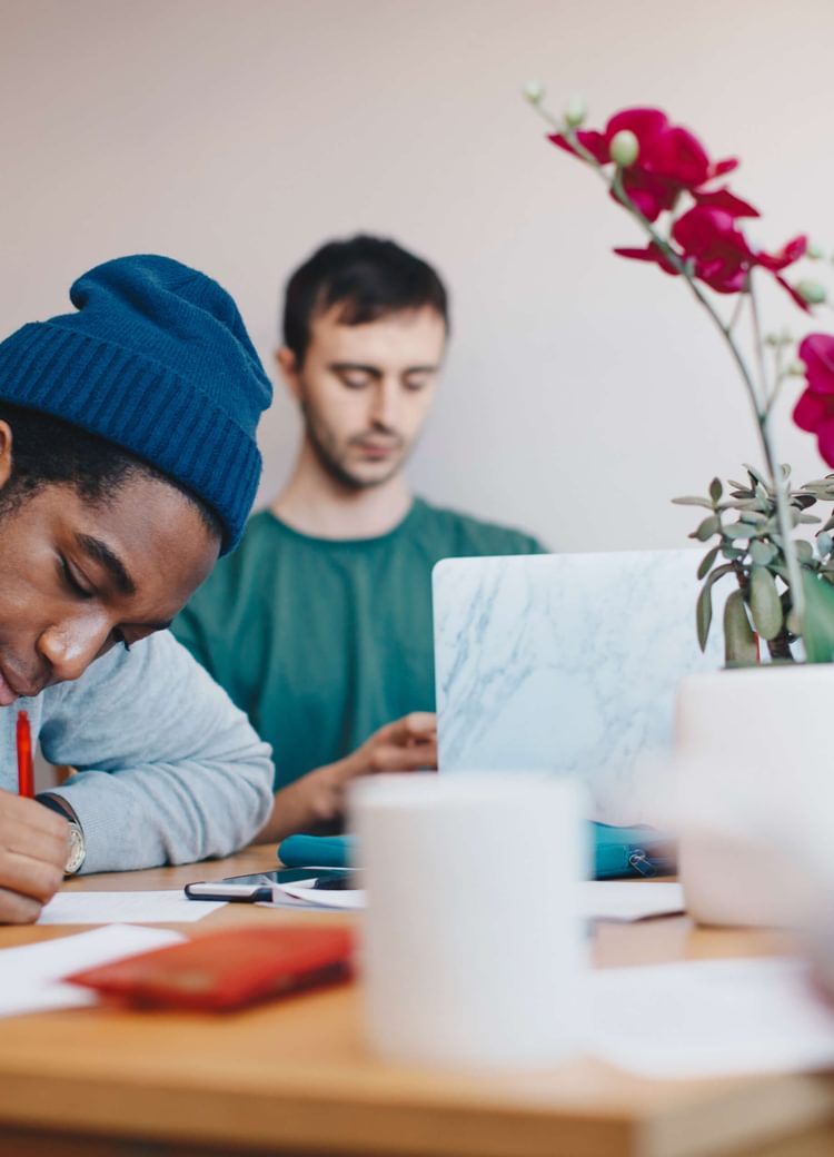 a student works on homework with a tutor
