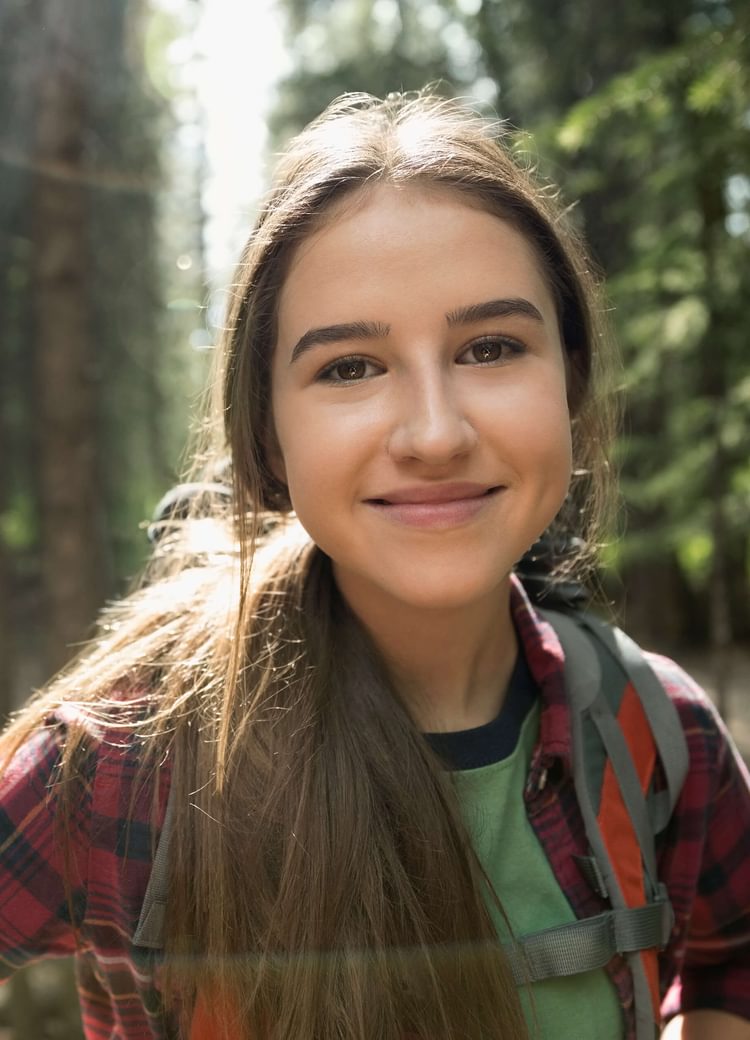 a young female dual enrollment student outside
