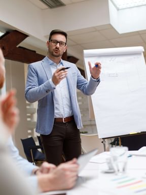 a man leads a presentation in a boardroom