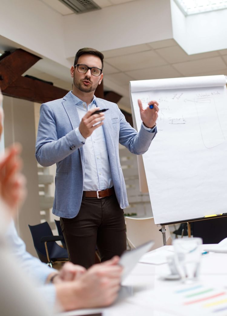 a man leads a presentation in a boardroom