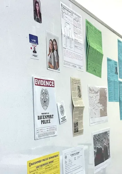 A crime scene board with evidence photos, police reports, and case documents used in a criminal justice class.