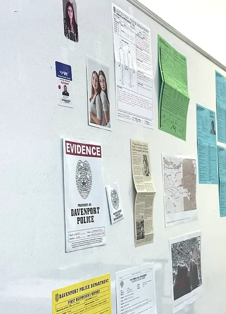 A crime scene board with evidence photos, police reports, and case documents used in a criminal justice class.