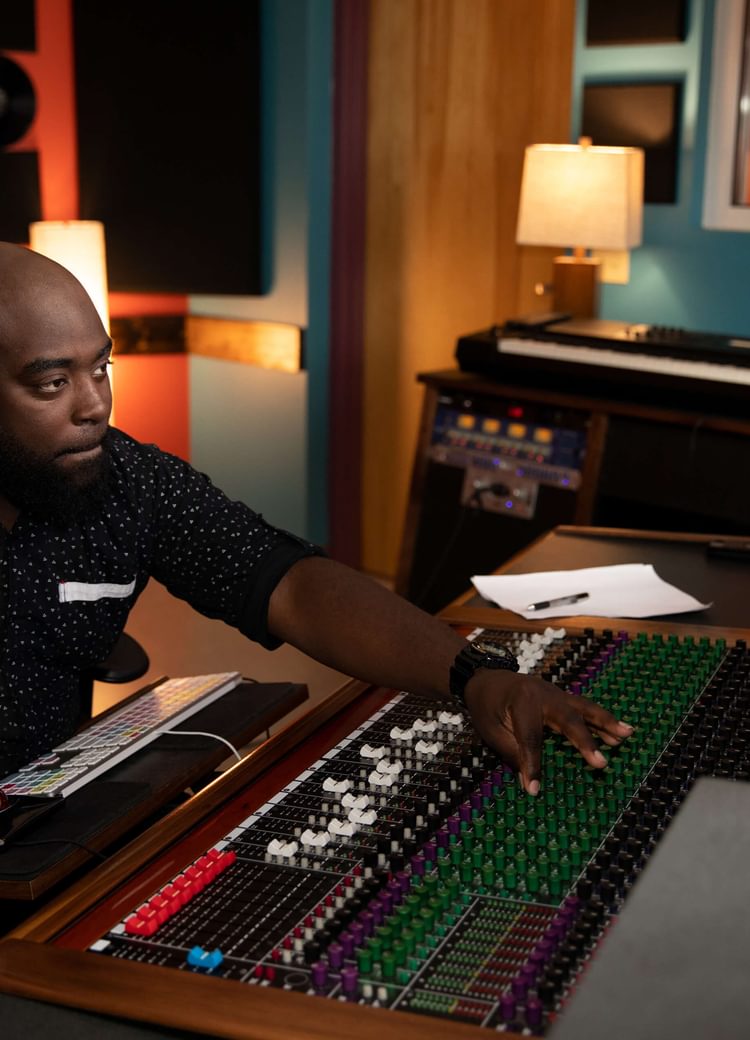 A sound engineer using the mixer in a recording studio