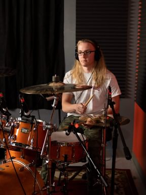 A drummer playing a drum kit