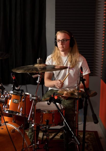 A drummer playing a drum kit