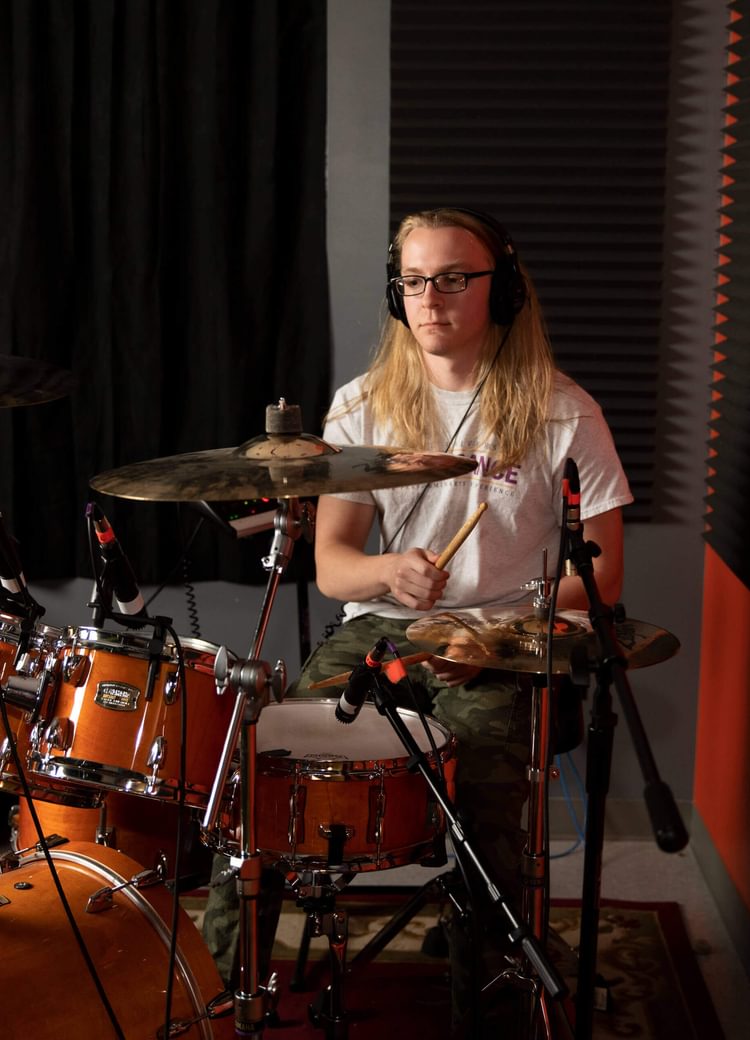 A drummer playing a drum kit