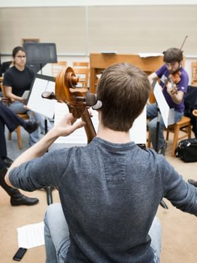 a group of musicians rehearse in a circle