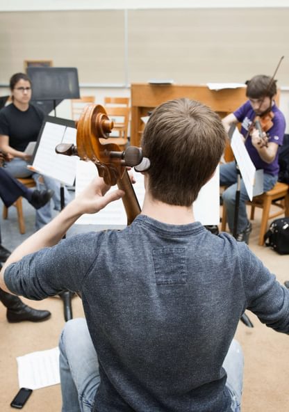 a group of musicians rehearse in a circle