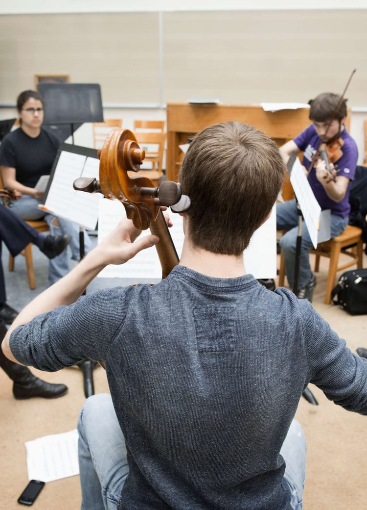 a group of musicians rehearse in a circle