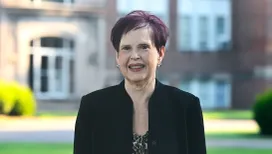 Dr. Delecia Parker smiling in front of Campbell Hall.