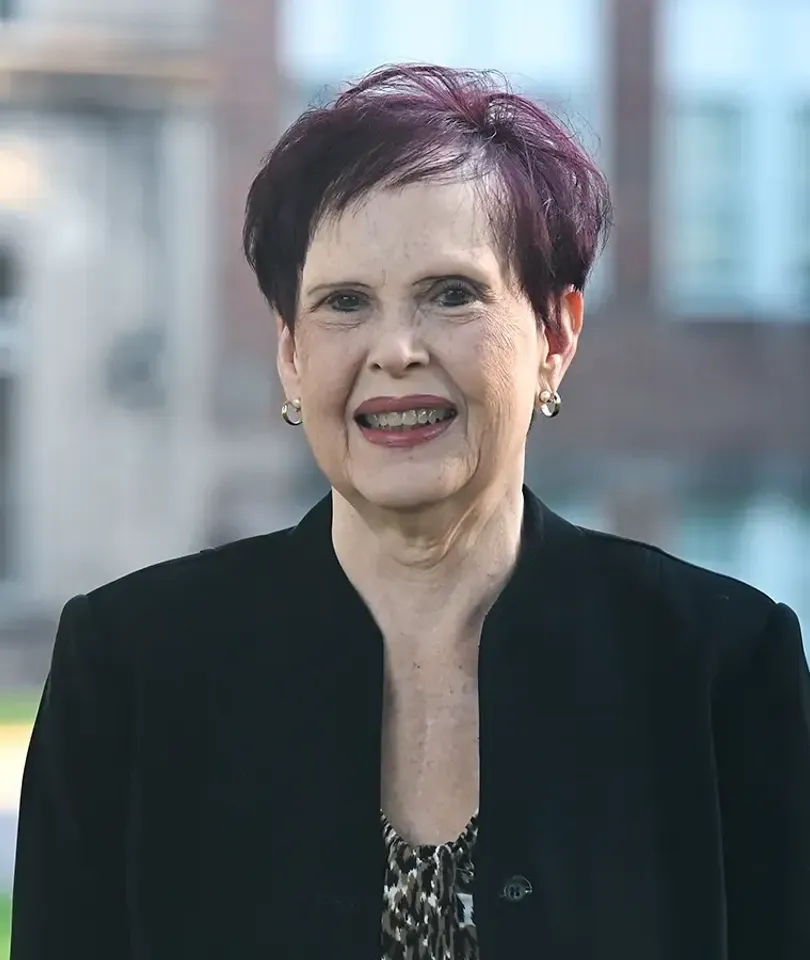 Dr. Delecia Parker smiling in front of Campbell Hall.