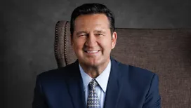 Professional portrait of Jody Hill wearing a suit and patterned tie.