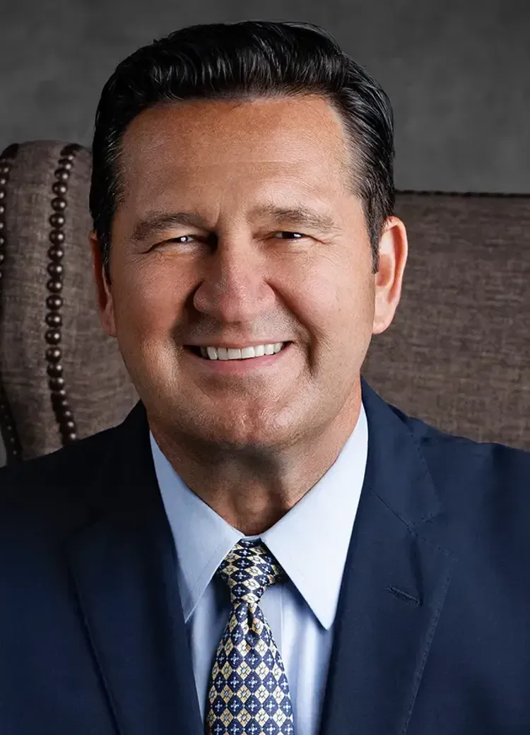 Professional portrait of Jody Hill wearing a suit and patterned tie.