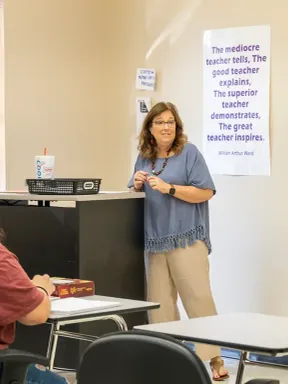 Professor teaching a group of students in an education course.