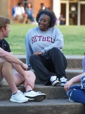 Students talking and spending time together on campus steps