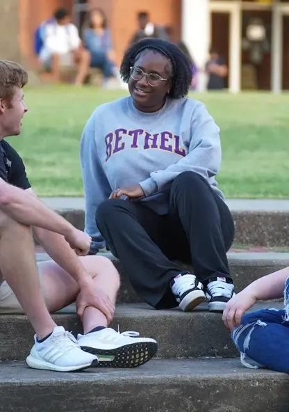 Students talking and spending time together on campus steps