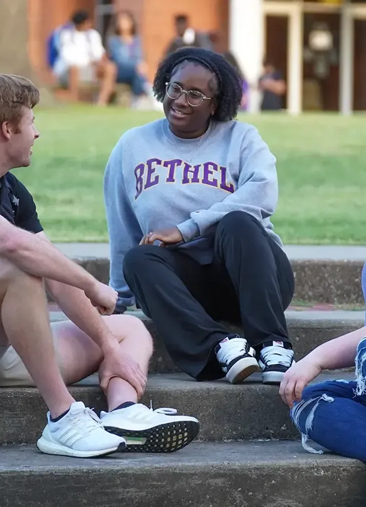Students talking and spending time together on campus steps