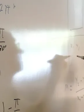 Mathematics professor writing equations on a classroom whiteboard.