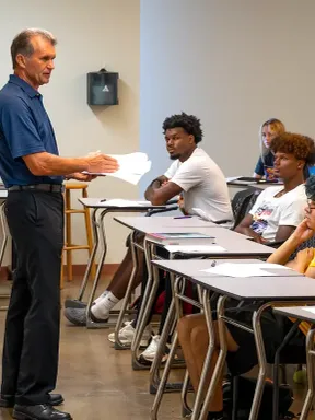 Professor speaking to students during a classroom lesson