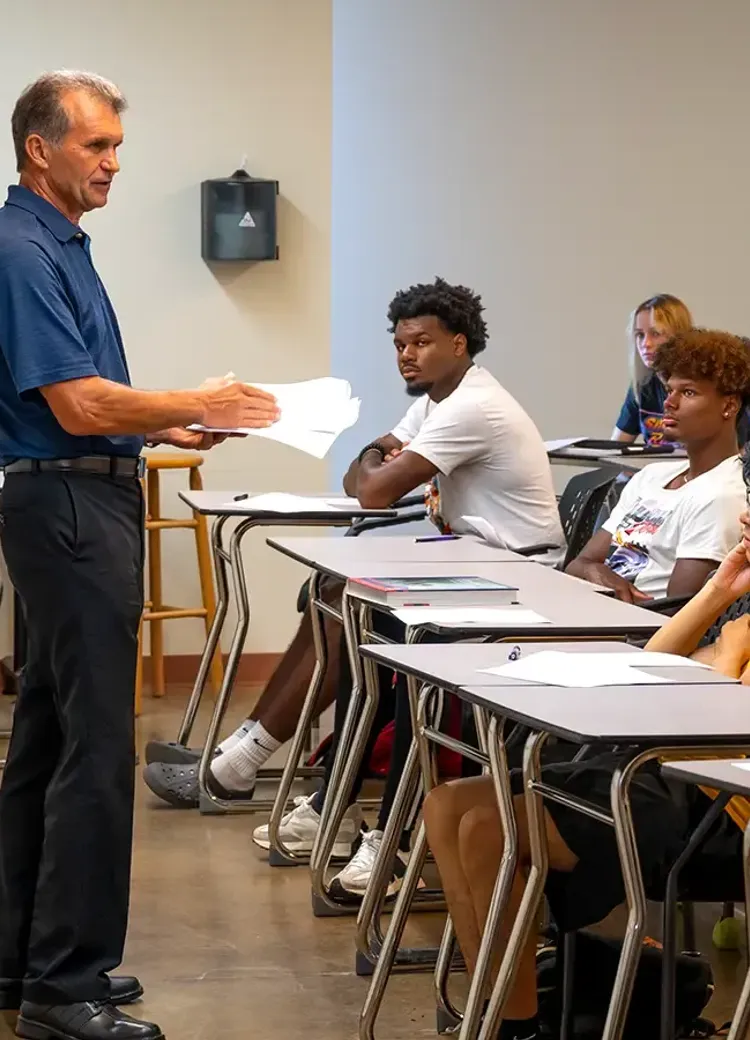 Professor speaking to students during a classroom lesson